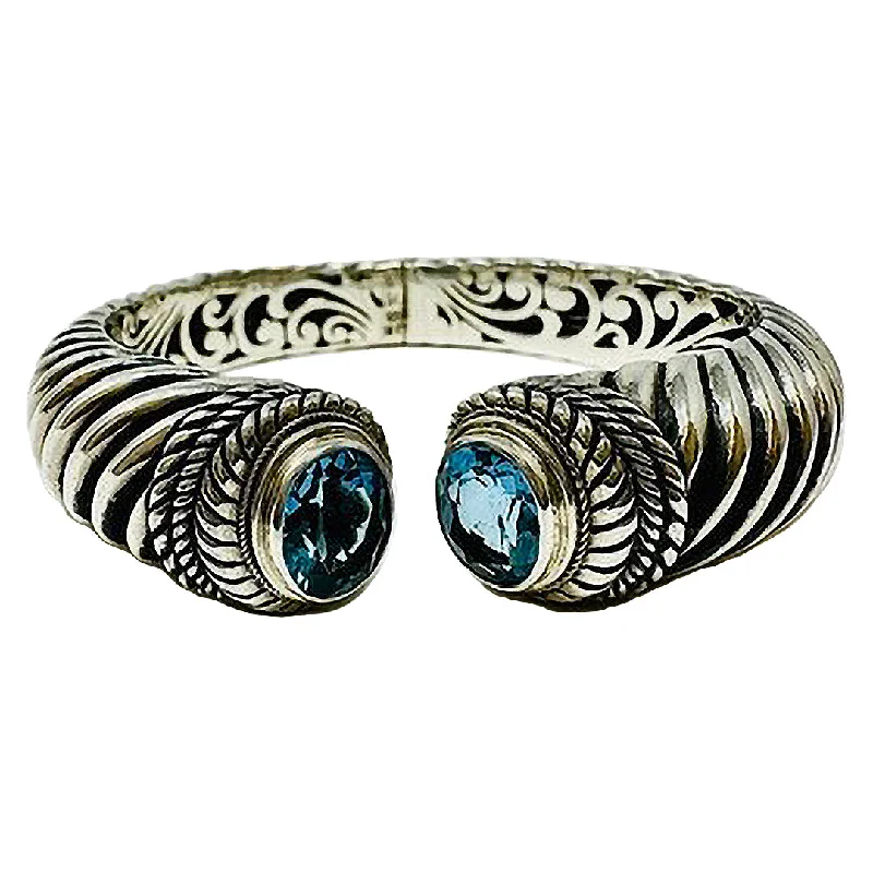 Premium Jewelry Now Available At Special Discounts Sterling Silver Hinged Bracelet with Blue Topaz and 18K Gold Accent Premium Jewelry Now Available At Special Discounts Sterling Silver Hinged Bracelet with Blue Topaz and 18K Gold Accent