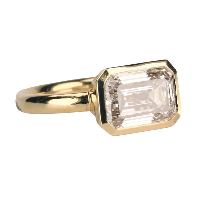 Timeless Elegance Now At Special Discounts 18K Gold "Piper" Ring with East-West Bezel-Set Lab Grown Emerald-Cut Diamond Timeless Elegance Now At Special Discounts 18K Gold "Piper" Ring with East-West Bezel-Set Lab Grown Emerald-Cut Diamond
